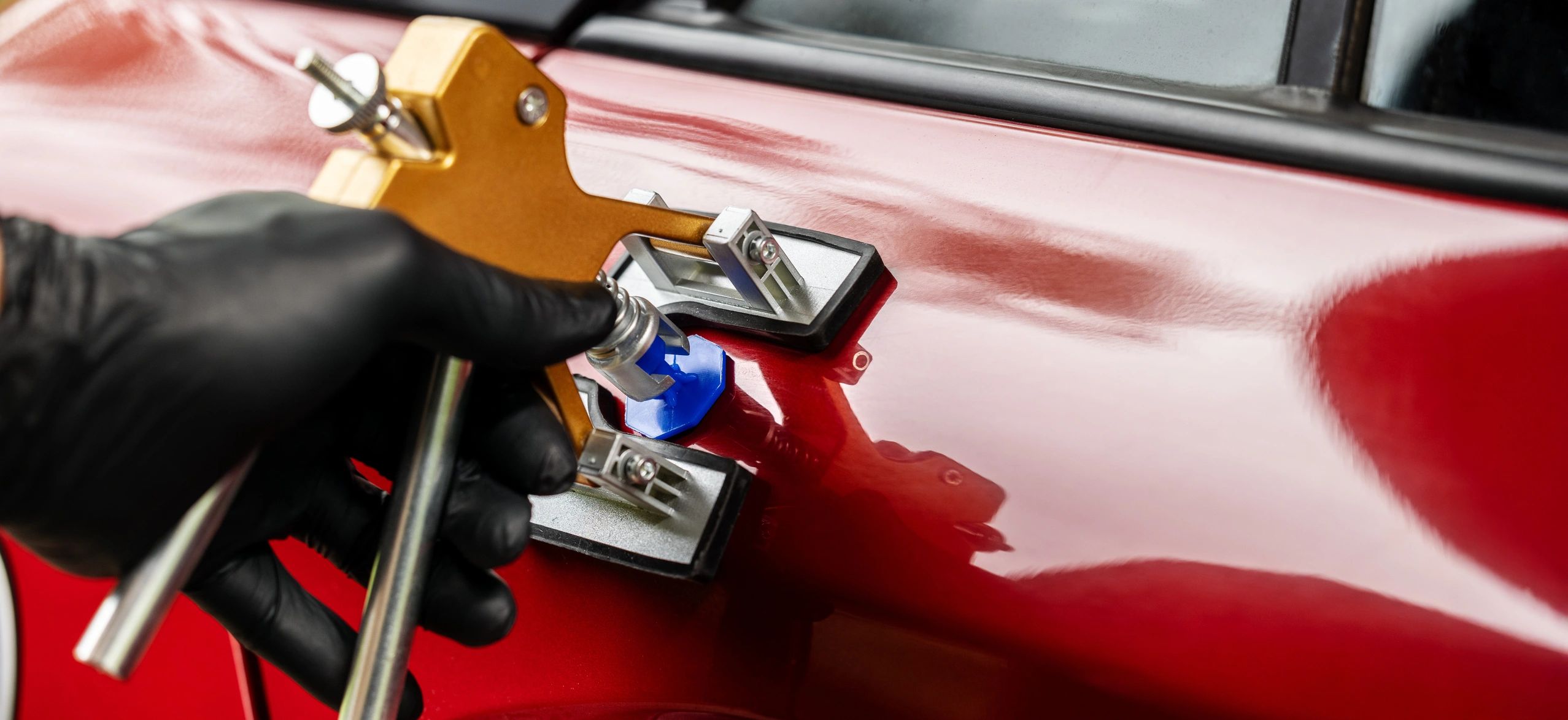 Technician performing car dent repair