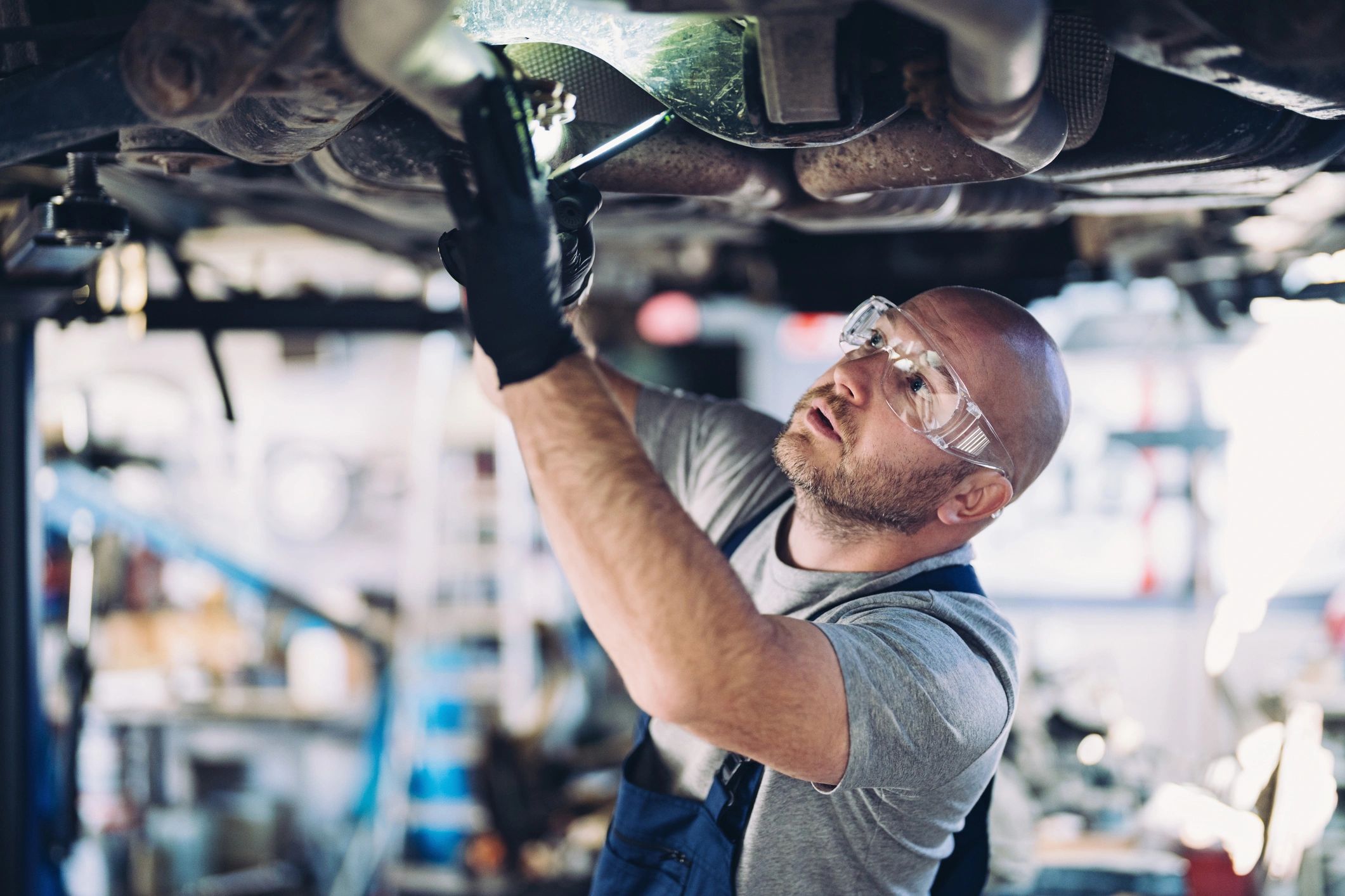 mechanic repairing car frame
